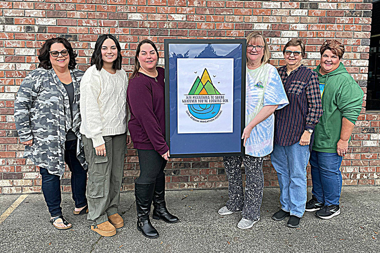 Sequim Gazette photo by Matthew Nash/ 
Members of the Sequim Irrigation Festivals marketing committee, from left, Deon Kapetan, Lily Williams, Michelle Rhodes, Vickie Maples, Jean Wyatt, and Robin Bookter stand with the festivals 129th logo made by Sherry Scharschmidt. The festival is held May 3-12, 2024.