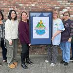 Sequim Gazette photo by Matthew Nash/ 
Members of the Sequim Irrigation Festivals marketing committee, from left, Deon Kapetan, Lily Williams, Michelle Rhodes, Vickie Maples, Jean Wyatt, and Robin Bookter stand with the festivals 129th logo made by Sherry Scharschmidt. The festival is held May 3-12, 2024.