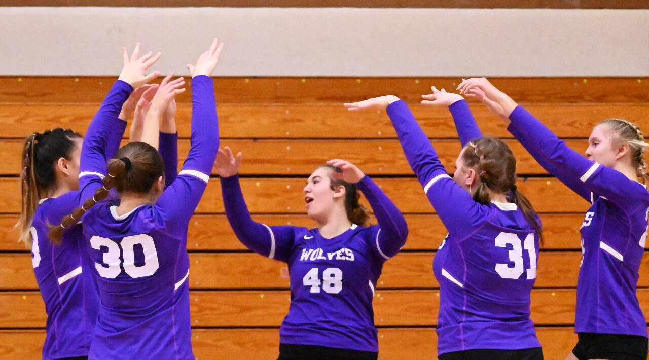 Sequim Gazette photo by Michael Dashiell / Sequims Sydney Hegvedt (48) and teammates celebrate a big block in a three-set sweep of Bremerton on Oct. 24.