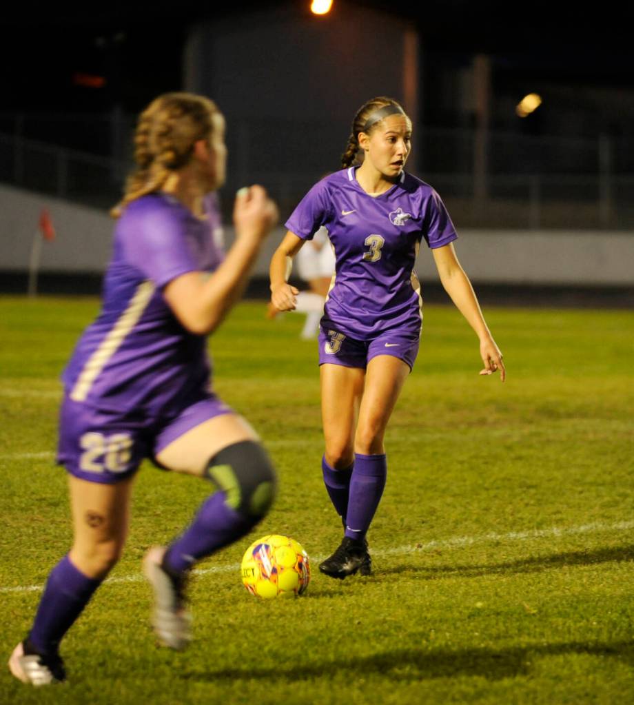 Sequim Gazette photo by Michael Dashiell / Sequims Taryn Johnson, right, pushes the ball upfield in the second half of a Sept. 26 Olympic League home game against Bainbridge. Johnson scored both goals in the 2-1 win, including the game-winner in double overtime.