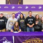 Sequim Gazette photo by Michael Dashiell / Friends, family and coaches join Sequim High senior Taryn Johnson, center, as she signs a letter of intent to play for Minnesota State University, Mankato, on Nov. 8 at the SHS library.
