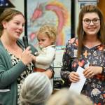 Sequim Gazette photos by Michael Dashiell
Brianne Lawson, treasurer with Peninsula Pre-3 Cooperative (with 16-month-old Charlie) and fellow board member Kelsey Wheeler accept a $4,150 grant from the Albert Haller Foundation last week.