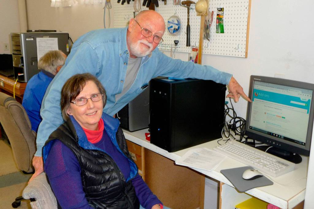 Sequim Gazette file photo by Patricia Morrison Coate/ Back in 2016, Tom LaMure and Kelly McKillip observe the first step in the process: wiping the hard drive clean of donated computers with the Sequim PC Users Group.