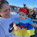 Alma Torres brings 5-month-old Gabriella Bahena around the Olympic Peninsula Rat Racers trunk-or-treat event for her first Halloween festivities as Snow White.
