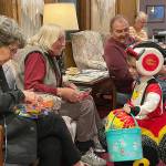 Sequim Gazette photOS by Matthew Nash
Dressed as AJ and Blaze from Blaze and the Monster Machines television show, Hunter Bushman, 3-and-a-half, trick-or-treats inside the Fifth Avenue on Halloween and receives candy from Carol Mcrae, Rosemary Freed and Norm Chojnicki.