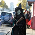 Sequim Gazette photo by Matthew Nash/ Beth Pratt, executive director of the Sequim-Dungeness Valley Chamber of Commerce, helps trick-or-treaters cross Washington Street on Halloween.
