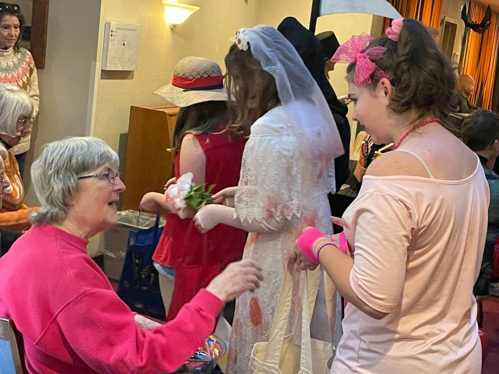 Sequim Gazette photo by Matthew Nash/ Olivia Knight dressed in 1980s attire goes trick-or-treating inside the Fifth Avenue on Halloween.