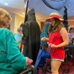 Sequim Gazette photo by Matthew Nash/ Lucca Schieffen dressed as Luffy from the anime and TV show One Piece trick-or-treats inside the Fifth Avenue on Halloween.