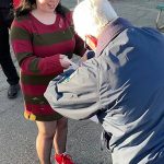 At right: Zoey Smith, dressed as Freddy Krueger, receives some candy from volunteer Sequim police officer Larry Smith on Halloween in Centennial Place.