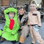 The Ghostbusters team of Max, 9, mom Jaycie, and Mary Wakefield, 4, find some treats at the Co-Op Farm & Garden on Halloween.