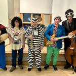Photo courtesy of Joey Lazzaro / In full holiday costume wear, members of The Cats Meow Swing Quartet take a break from entertaining the Port Angeles Senior Centers The Senior Swingers dance club on Halloween. Pictured, fromleft, are John Zuerner (saxophone), Jack Smith (drums), Joey Lazzaro (trumpet/flugelhorn), Richard Crowell (guitar) and Brennan Van Blair (bass).