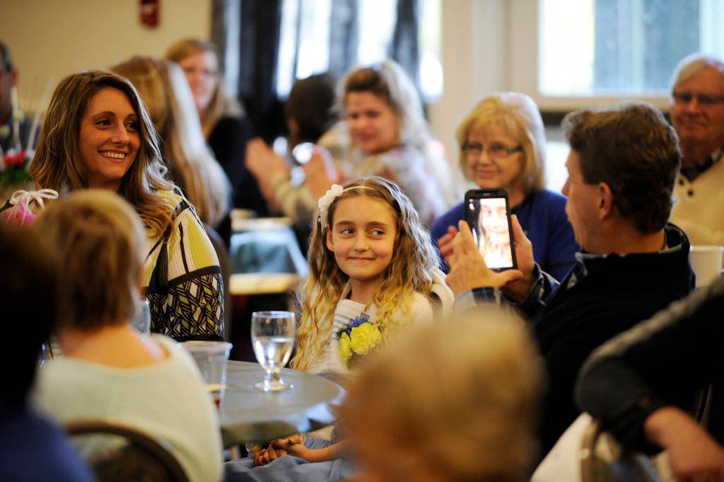 Sequim Gazette file photo by Michael Dashiell/ River Jensen, center, a finalist for the 2016 Sequim Citizen of the Year, gets her photo taken during the luncheon.