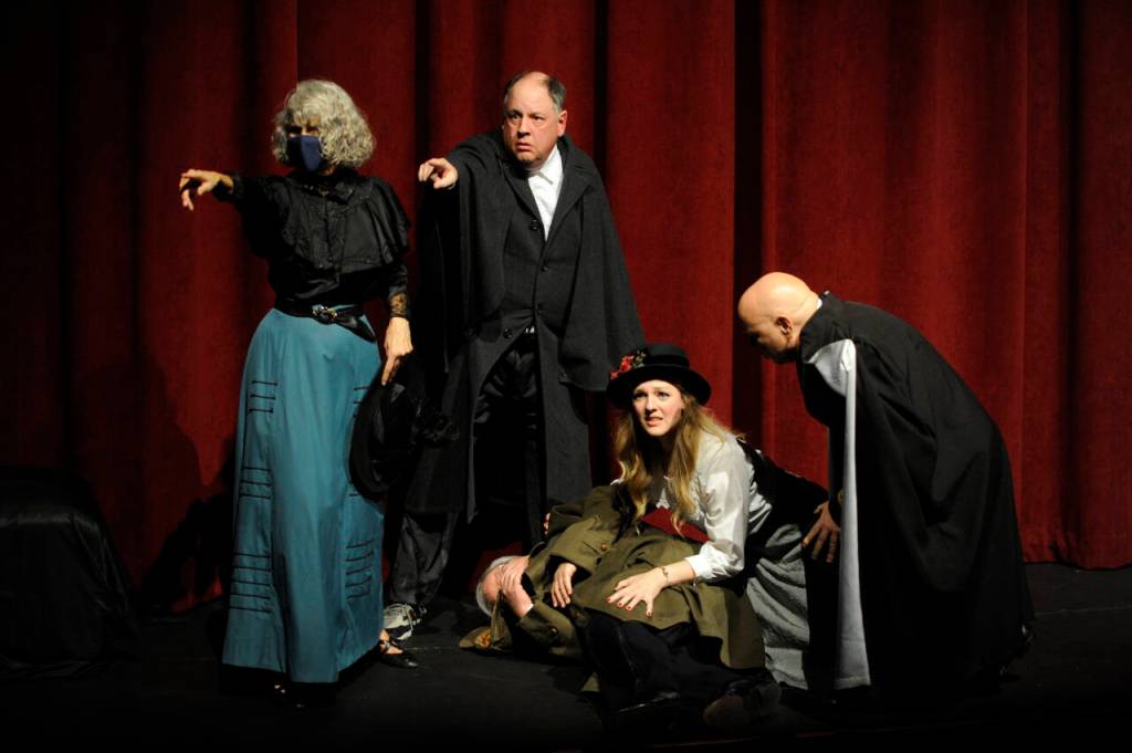 Sequim Gazette photo by Michael Dashiell / Fellow actors look for the assailant following a play-within-a-play Olympic Theatre Arts The Games Afoot or Holmes for the Holidays. Veteran stage actor William Gillette (portrayed by Joel Hoffman) is gunned down, and fellow thespians Madge Geisel (Cheryl Tamblyn), Felix Geisel (Steve Rodeman), Aggie Wheeler (Merrin Packer) and Simon Bright (Stephan Willms) come to his aid.