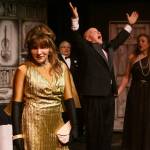 Sequim Gazette photo by Michael Dashiell / Acerbic magazine columnist Daria Chase (portrayed by Jamie Pauley) reveals that newly-married Simon Bright (Stephan Willms) has inherited a fortune in an early scene of The Games Afoot or Holmes for the Holidays. Looking on are host William Gillette (Joel Hoffman) and Brights new bridge, Aggie Wheeler (Merrin Packer).