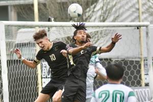 Peninsula College's Nil Grau, left, and Abdurahim Leigh battle for a ball in front of the Highline net Sunday in Tukwila. (Jay Cline/Peninsula College)