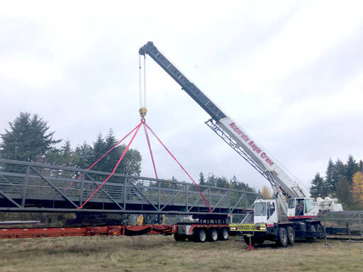 Photo courtesy of Clallam County Public Works / A bridge section that was formerly used as a walkway from downtown Seattle is unloaded at a Clallam County gravel pit facility.
