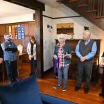 Betsy Reed Schultz (fourth from left), founder of Captain Joseph House, gives a tour last week of the Port Angeles facility that offers respite for Gold Star families.