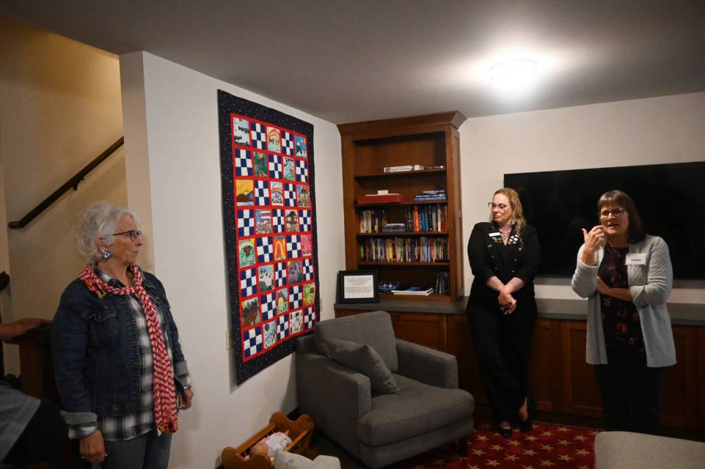 Sequim Gazette photo by Michael Dashiell / Betsy Reed Schultz (left), founder of Captain Joseph House, gives a tour last week of the Port Angeles facility that offers respite for Gold Star families. The family craft room (pictured) features a quilt featuring student artwork.
