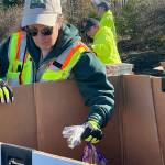 Sequim Gazette photo by Matthew Nash/ Laura Johns, a Community Emergency Member Team (CERT) member, readies some food for the Family Holiday Meal Bag Distribution program.