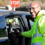 Sequim Gazette photo by Matthew Nash/ Volunteer Lynie Staus greets a dog during the Family Holiday Meal Bag Distribution program that helped provide more than 1,000 meal boxes on Nov. 17.