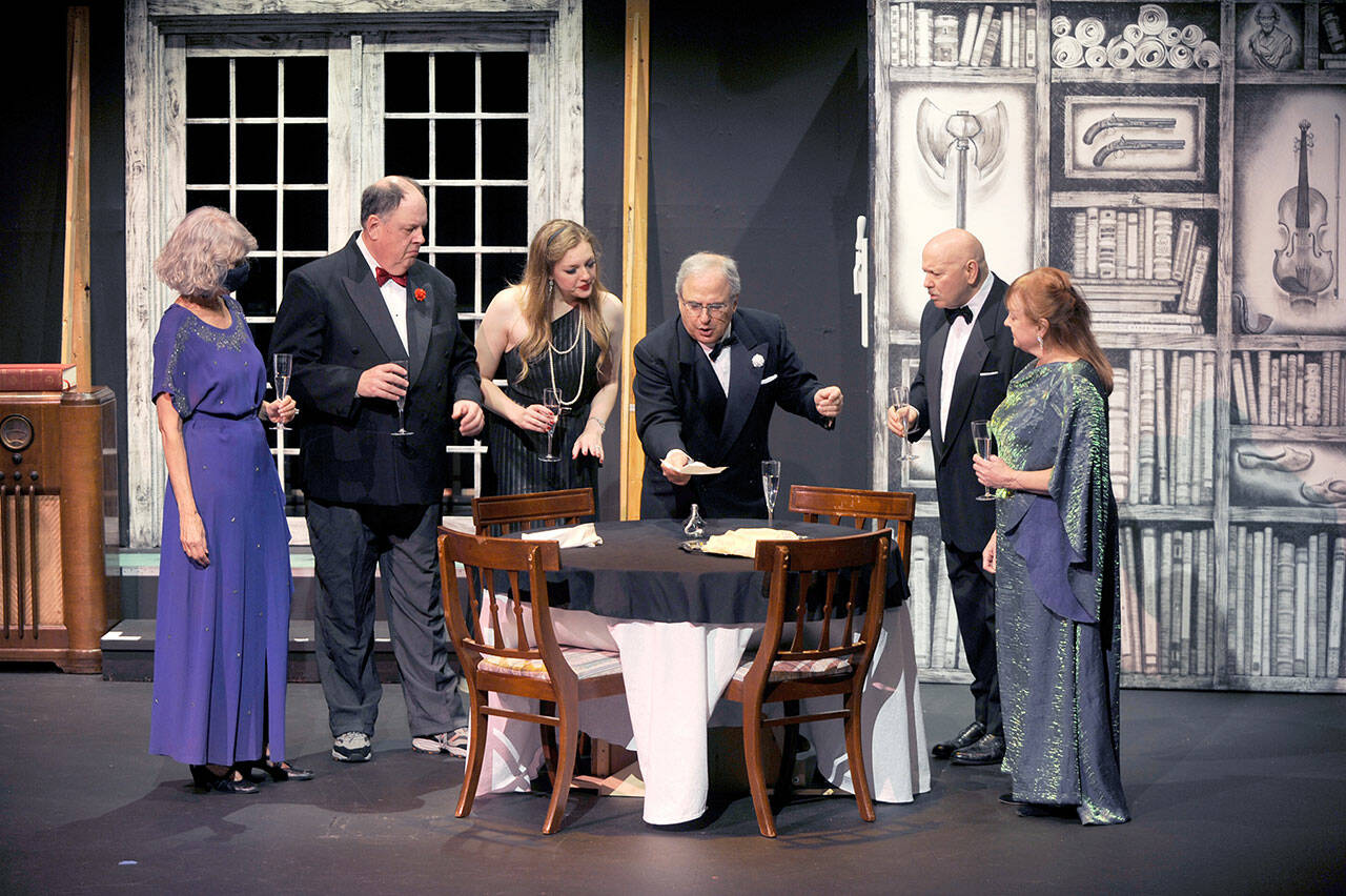 Sequim Gazette photo by Michael Dashiell
William Gillette (portrayed by Joel Hoffman, fourth from left) finds a note that reveals that a stage doorman where he and fellow thespians work has just been murdered  suggesting the killer is most likely one of the guests hes hosting. Looking on are, from left, Madge Geisel (Cheryl Tamblyn), Felix Geisel (Steve Rodeman), Aggie Wheeler (Merrin Packer), Simon Bright (Stephan Willms) and Martha Gillette (Cheryl DiPietro). The opening of this murder-mystery has been postponed to Dec. 8 and runs through Dec. 17, with shows on Fridays and Saturdays at 7 p.m. and 2 p.m. on Sundays. Two performances are added to make up for the postponed weekend: 7 p.m. on Thursday, Dec. 14, and 2 pm. on Saturday, Dec. 16 (in addition to the 7 p.m. performance on that date).