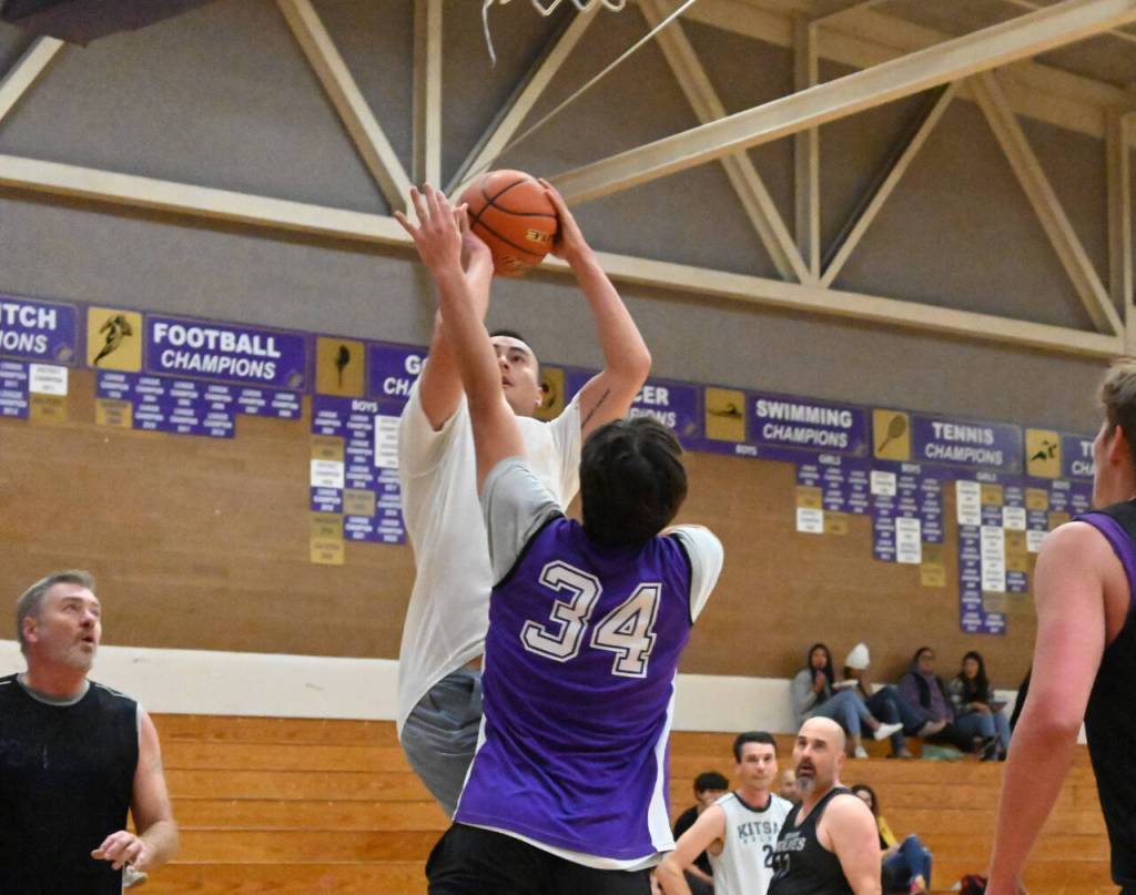 Sequim Gazette photo by Michael Dashiell / Former Olympic League MVP Alex Barry shoots over fellow Sequim High alum Cole Smithson in the schools annual alumni game on Nov. 24.