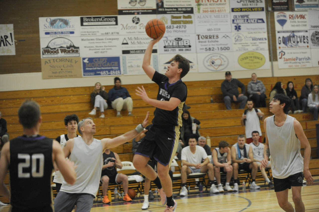 Sequim Gazette photos by Michael Dashiell
Sequim High senior Keenan Green, pictured here driving in for a basket in SHSs alumni game in November, returns to lead the Wolves in 2023-24.