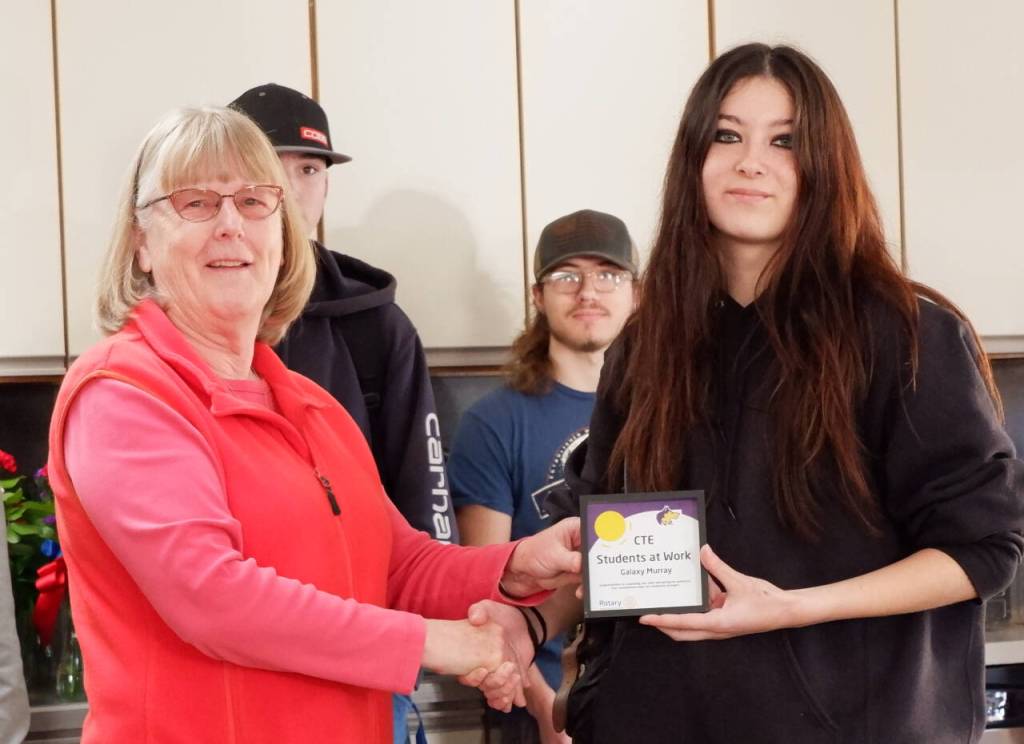 Photo courtesy of Sequim School District / Kathy Strozyk of Sequim Sunrise Rotary hands Sequim high School student Galaxy Murray