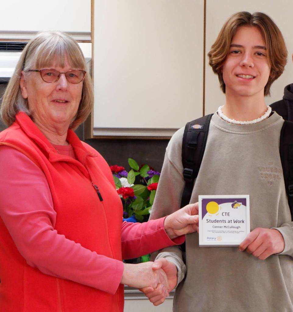 Photo courtesy of Sequim School District / Kathy Strozyk of Sequim Sunrise Rotary hands Sequim high School student Conner McCullough