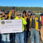 Sequim Gazette photo by Matthew Nash
Sequim Valley Lions Club members donate $1,000 to the Sequim Food Bank to help the non-profit with its Family Holiday Meal Bag program.