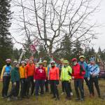 Sequim Gazette photo by Michael Dashiell / Local bicyclists finish decorating the tree near the Sequim Welcomes You sign on Nov. 29. The ornament and tinsel decorating has become something of an annual tradition at the tree located on the east end of town near Whitefeather Way, between the Olympic Discovery Trail and U.S. Highway 101.