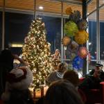 Sequim Gazette photo by Michael Dashiell / Sarah Hurt, City of Sequim arts coordinator, lights up the Civic Center Holiday Tree at the annual lighting ceremony and open house on Dec. 1. The tree is decorated with ornaments created by local fourth grade/9-year-old students; the theme for this years ornaments was What Brings You Joy? Mayor Tom Ferrell read aloud short messages from local students based on the theme, and Tom Schindler and fellow musicians provided holiday-themed music.