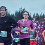 Photo by Run the Peninsula / John Mauro of Port Townsend (731), Tyler Larson of Silverdale (509) and Dustin Hines of Port Townsend break from the starting line at the Jamestown Glow Run on Dec. 2. Mauro placed first and Larson second in the 10k while Hines took second in the 5k.