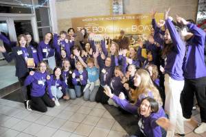 Members of the Sequim High School Interact Club respond to a prompt to show excitement for a television crew following Friday night's special screening of "The Boys in the Boat" at Deer Park Cinemas in Port Angeles. (Keith Thorpe/Peninsula Daily News)