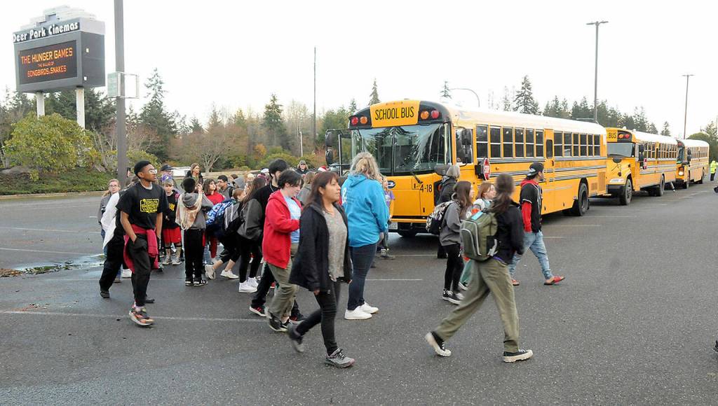 Photo by Keith Thorpe/Olympic Peninsula News Group / Sequim students unload from buses in front of Deer Park Cinemas in Port Angeles for the Dec. 8 advance screening of The Boys in the Boat.