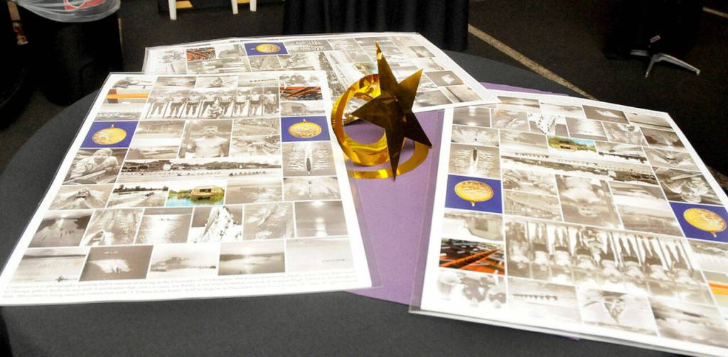 Special-made placemats showing historical pictures of Joe Rantz and the University of Washington rowing team sit on a table during a fundraising gala for the Joe Rantz Rotary Youth Fund at the Sequim Museum & Arts on Dec. 8.
