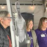 Sequim Gazette photo by Matthew Nash/ During the Tribute to Joe Rantz event at the Sequim Museum and Arts, Craig Robinson, Chelsea Reichner and Colleen Robinson pose for a photo with a cutout of Joe Ratnz.