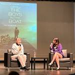 Sequim Gazette photo by Matthew Nash
Judy Willman, the daughter of Joe Rantz, is interviewed by Danika Chen, a 2023 Sequim graduate, in the Sequim High School Auditorium on Dec. 8 about elements of The Boys in the Boat film and how her father is portrayed. Willman said her dad would not want attention but would be okay with it if it supported causes such as restoring the historic ASUW Shell House and building a homeless youth house in Sequim.