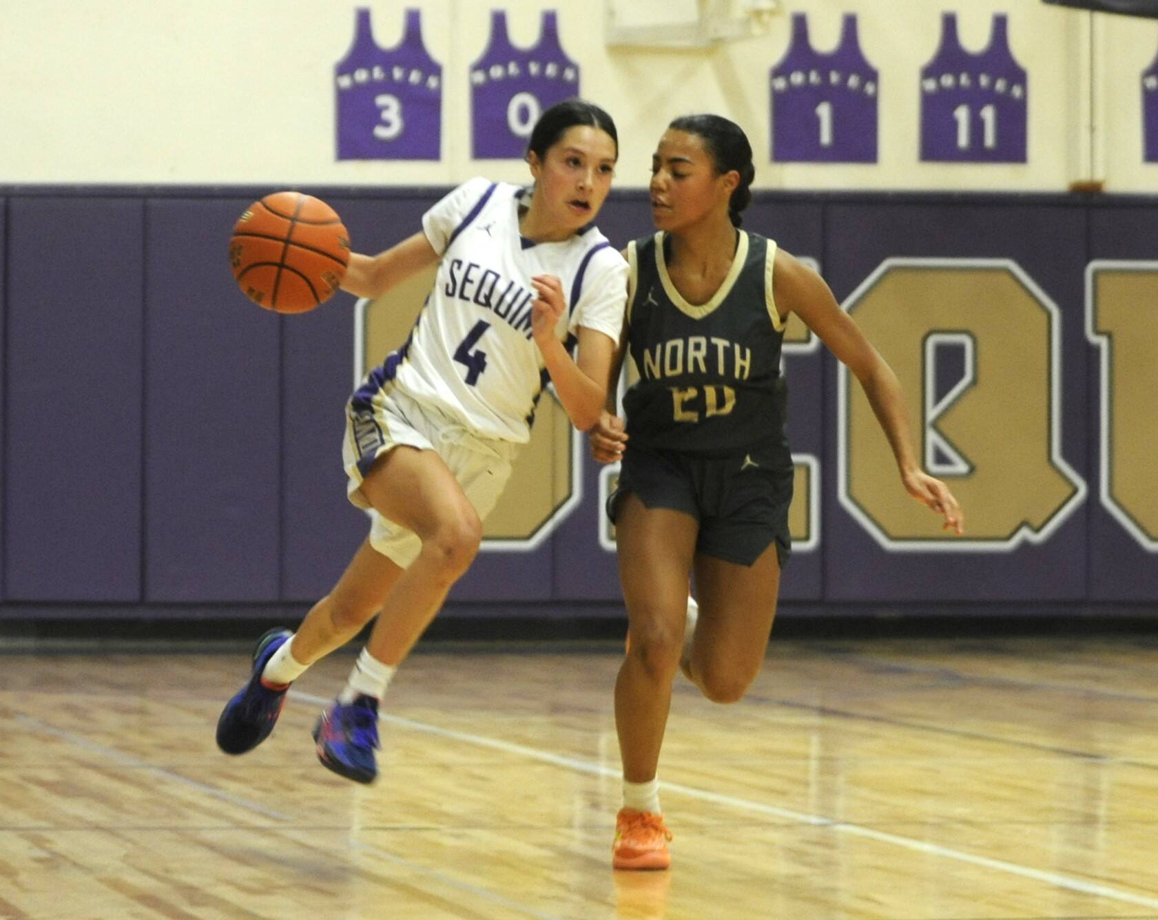 Sequim Gazette photoS by Michael Dashiell
Sequims Gracie Chartraw, left, drives by North Kitsaps Coriana McMillian in the Wolves 56-40 win on Dec. 15.