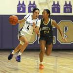 Sequim Gazette photoS by Michael Dashiell
Sequims Gracie Chartraw, left, drives by North Kitsaps Coriana McMillian in the Wolves 56-40 win on Dec. 15.
