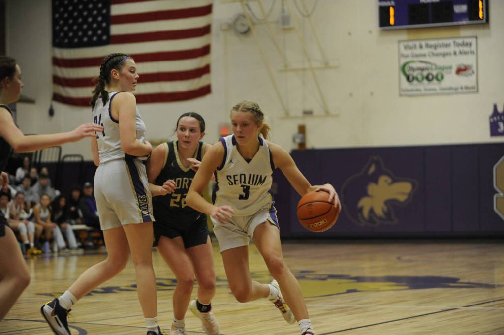 Sequim Gazette photo by Michael Dashiell / Sequims Jolene Vaara, right, gets a screen from teammate Dani Herman in the first half of the Wolves 56-40 win over North Kitsap on Dec. 15.