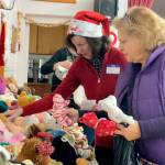 Sequim Gazette photo by Matthew Nash/ Helene Weiner helps Mary Kay McCabe find the right animals for her foster children at Toys for Sequim Kids.