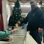 Sequim Gazette photo by Matthew Nash/ Jim Ryan, left, helps Kenneth Weeda choose a bike for a raffle at Toys for Sequim Kids. Murreys Olympic Disposal donated 22 bikes this year, organizers said.