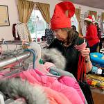 Sequim Gazette photoS by Matthew Nash
Deidre Davitt helps a parent at Toys for Sequim Kids pick a coat for a child on Dec. 12 inside the Sequim Prairie Grange. The event helped 435 children receive presents for Christmas.