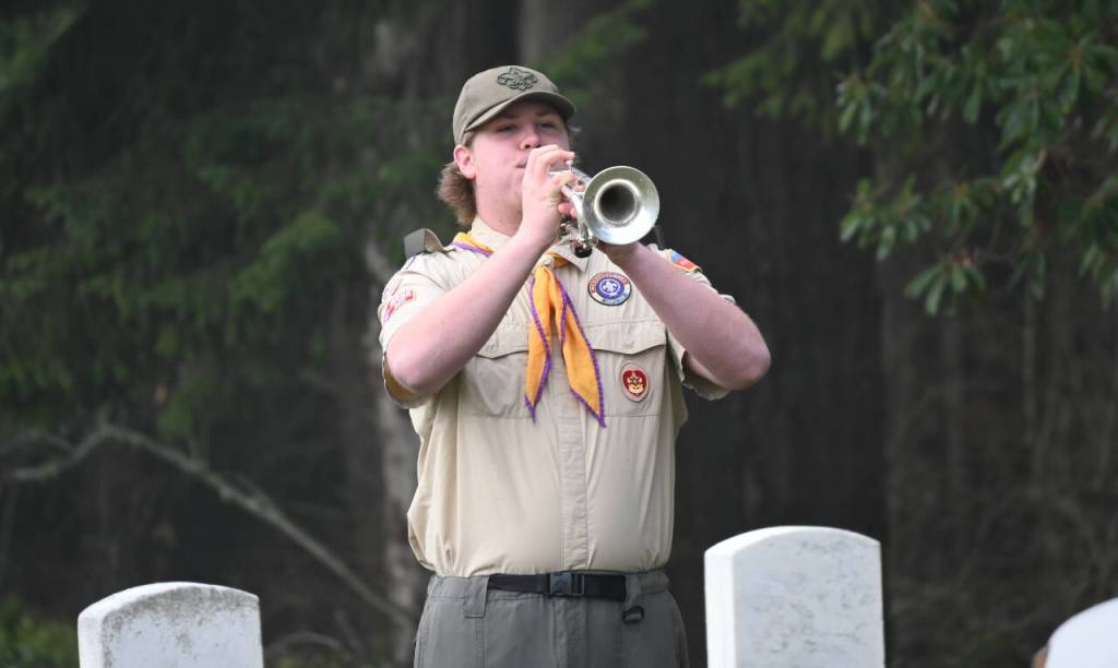 Sequim Gazette photo by Michael Dashiell / BSA Troop 90 scours Aaron Wallen plays Taps at a ceremony honoring veterans at Sequim View Cemetery on Dec. 16.