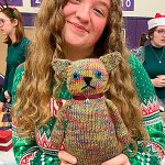 Sophomore Jessie Bainbridge holds up a knitted cat she received from teacher Laura Gould at Sequim High Schools Winter Wishes assembly on Dec. 18. Bainbridge said she had Gould as a teacher last year and this year and knew she knitted. I love it so much, and I love Mrs. Gould! she said.