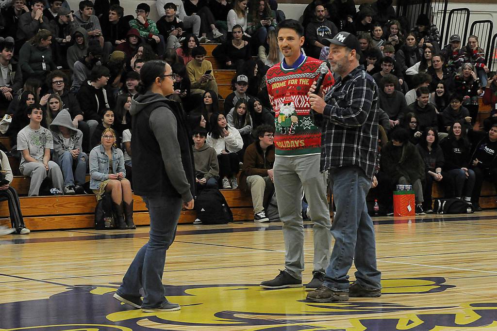 Sequim Gazette photo by Matthew Nash/ Freshman Elizabeth Howard learns from teachers Sean OMera and Bill McFarlen that she was gifted a scholarship to participate in the upcoming trapshooting season with Sequim FFA.