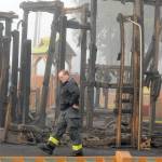Photo by Keith Thorpe/Olympic Peninsula News Group / Assistant Fire Chief Mike Sanders walks past the remains of a play structure at the Dream Playground on Dec. 20.