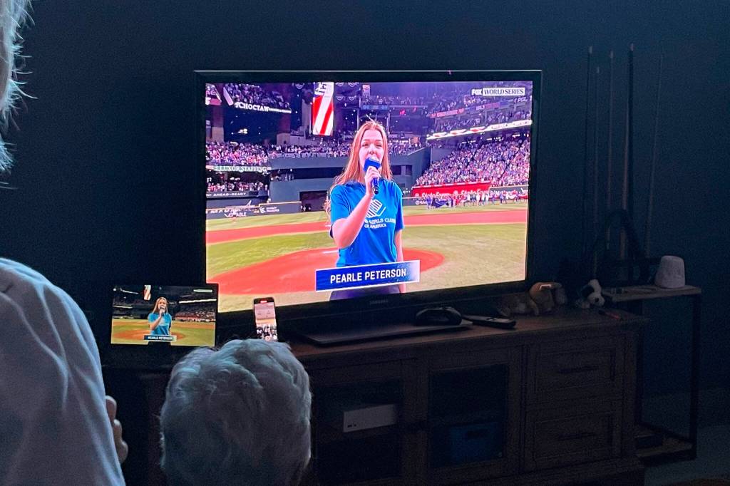 Sequim Gazette photo by Matthew Nash/ About 30 people gathered inside the Sequim Boys & Girls Club to watch Pearle Peterson sing during the World Series on Oct. 28.