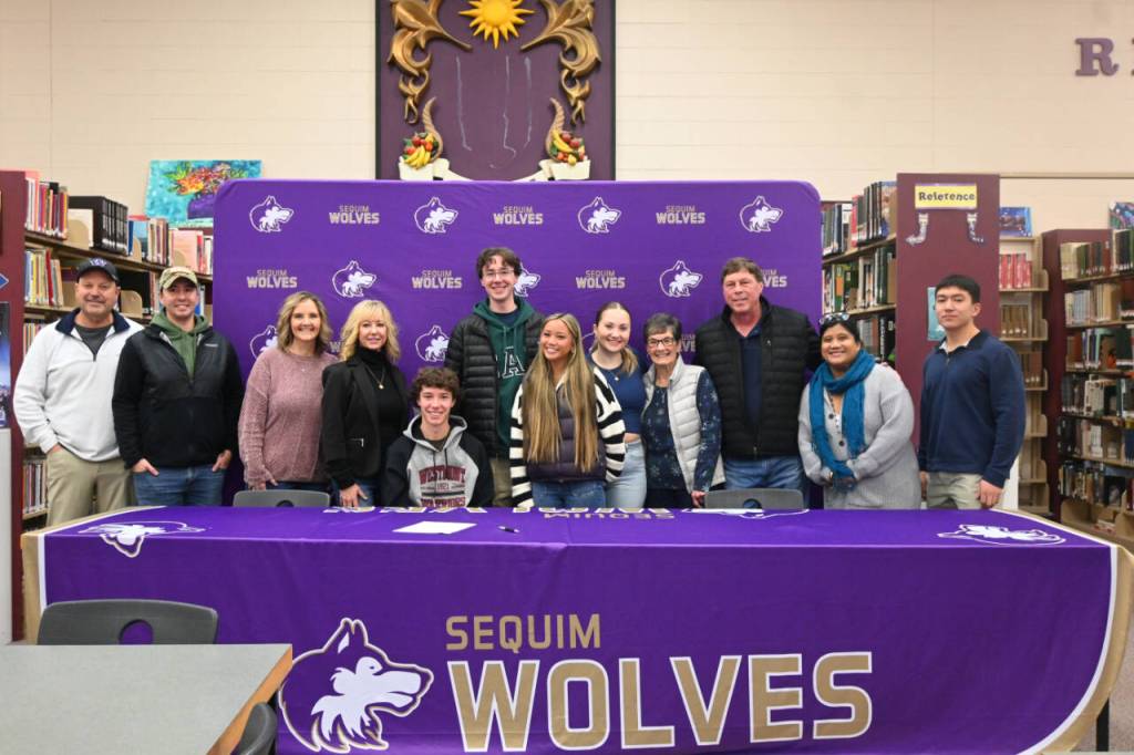 Sequim Gazette photo by Michael Dashiell / Sequim High senior Garrett Little (seated) is joined by friends and family at a letter-of-intent signing ceremony on Dec. 22 at the SHS library. Little amassed an undefeated league record, three league titles, a district title and two to-three finishes (so far) at state tournaments, and plans to play at Westmont College in Santa Barbara, Calif., after graduation.